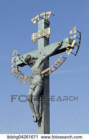 Stock Image - Crucifix with Hebrew script, Charles Bridge, Prague, Czech Republic, Europe. Fotosearch