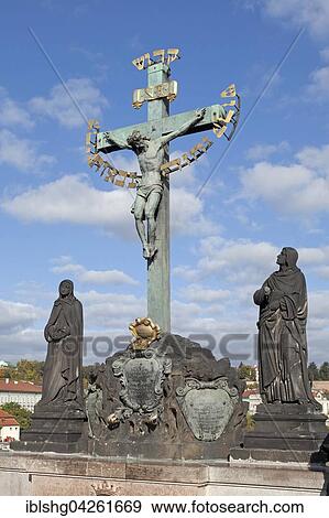 Stock Photo - Crucifix with Hebrew script, Charles Bridge, Prague, Czech Republic, Europe. Fotosearch