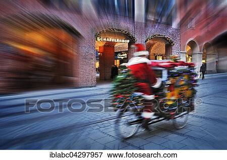 Driving Santa Claus with presents on bicycle, Munich, Bavaria, Germany, Europe View Large Photo Image Stock Photo - Driving Santa Claus with presents on bicycle, Munich, Bavaria, Germany, Europe. Fotosearch