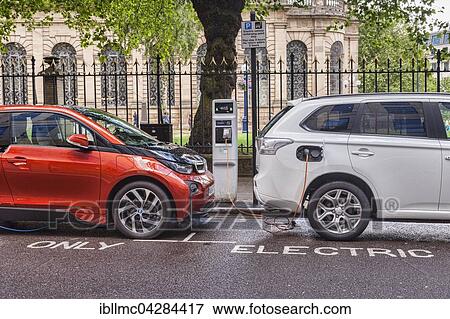 Electric cars being charged in centre of Birmingham, West Midlands, England View Large Photo Image Stock Photo - Electric cars being charged in centre of Birmingham, West Midlands, England. Fotosearch