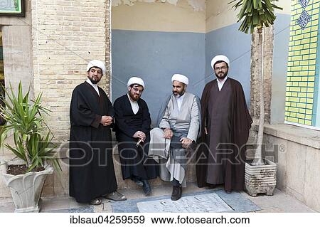 Stock Photo - Four mullahs with turbans and long robes, Shiite clerics, Ali Ebn Mosque Imamzadeh-ye-e Hamze or Ali ibn Ahmad ibn Hamza, Mausoleum, grave mosque, Shiraz, Iran, Asia. Fotosearch