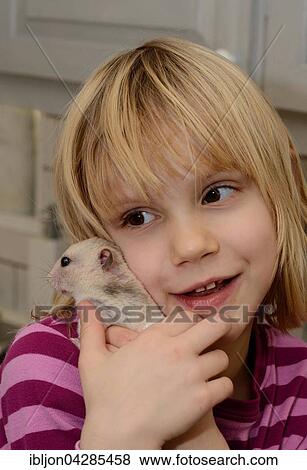 Girl, six years old, with a hamster, Ystad, Scania, Sweden, Europe View Large Photo Image Stock Photo - Girl, six years old, with a hamster, Ystad, Scania, Sweden, Europe. Fotosearch