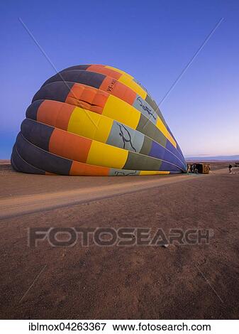 Hot air balloon being filled with air, Kulala Wilderness Reserve, Namib Desert, Tsaris Mountains, Hardap Region, Namibia, Africa View Large Photo Image Stock Photo - Hot air balloon being filled with air, Kulala Wilderness Reserve, Namib Desert, Tsaris Mountains, Hardap Region, Namibia, Africa. Fotosearch