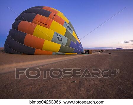 Hot air balloon being filled with air, Kulala Wilderness Reserve, Namib Desert, Tsaris Mountains, Hardap Region, Namibia, Africa View Large Photo Image Stock Photography - Hot air balloon being filled with air, Kulala Wilderness Reserve, Namib Desert, Tsaris Mountains, Hardap Region, Namibia, Africa. Fotosearch