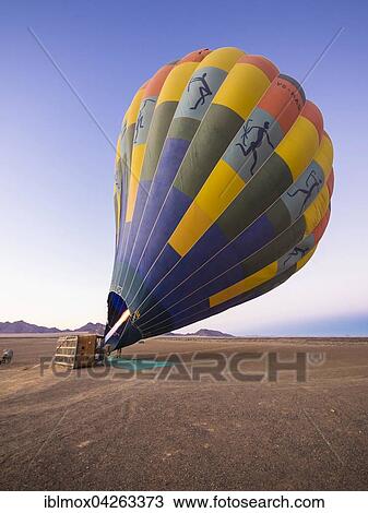 Hot air balloon being heated up, Kulala Wilderness Reserve, Namib Desert, Tsaris Mountains, Hardap Region, Namibia, Africa View Large Photo Image Stock Image - Hot air balloon being heated up, Kulala Wilderness Reserve, Namib Desert, Tsaris Mountains, Hardap Region, Namibia, Africa. Fotosearch
