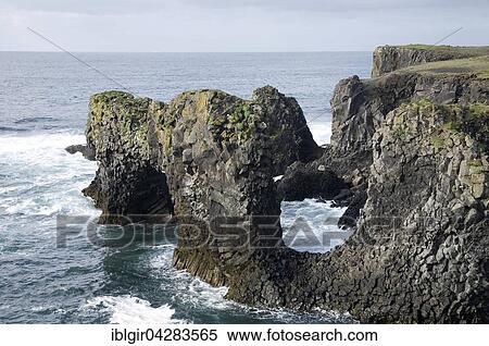 Stock Photography - Lava rock in sea at coast, Arnarstapi, Iceland, Europe. Fotosearch
