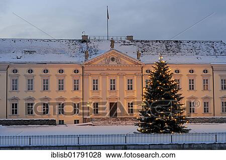 Stock Photo - Main entrance of Bellevue Palace, residence of the German Federal President, with a Christmas tree at Christmas season, Berlin, Germany, Europe. Fotosearch