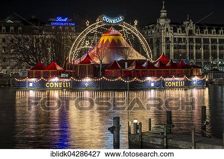 Stock Photo - Night scene, view from the Quai Bridge on the River Limmat with the Bauschanzli, Christmas circus Conelli, Zurich, Zurich, Switzerland, Europe. Fotosearch