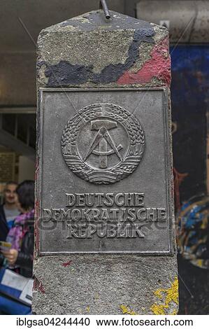 Stock Image - Old concrete pillar of the Inner German border with sign Deutsche Demokratische Republik or German Democratic Republic, Berlin, Germany, Europe. Fotosearch
