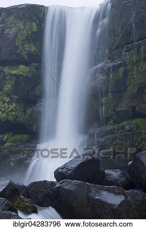 Stock Photograph - Oxarafoss waterfall, Oxara River, Thingvellir National Park, Hvalfjorour, Iceland, Europe. Fotosearch