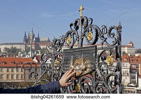 Person touching a saint's depiction, Charles Bridge, Prague, Czech Republic, Europe View Large Photo Image Stock Photo - Person touching a saint's depiction, Charles Bridge, Prague, Czech Republic, Europe. Fotosearch