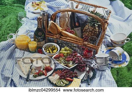 Picture - Picnic basket with champagne, wine, cheese and fruit. Fotosearch