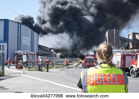 Police officer with safety vest at a major fire, Lower Saxony, Germany, Europe View Large Photo Image Stock Photo - Police officer with safety vest at a major fire, Lower Saxony, Germany, Europe. Fotosearch