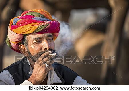 Portrait of Rajasthani man with turban smoking a cigarette, Pushkar, Rajasthan, India, Asia View Large Photo Image Stock Image - Portrait of Rajasthani man with turban smoking a cigarette, Pushkar, Rajasthan, India, Asia. Fotosearch