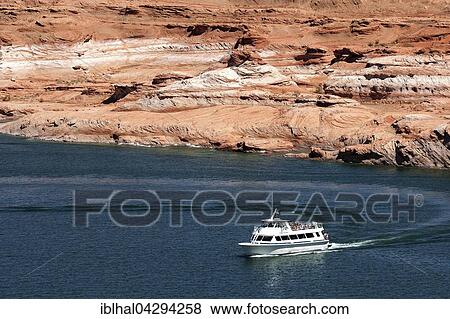 Red Navajo Sandstone cliffs at Lake Powell, excursion boat in Wahweap Bay, Page, Arizona, USA, North America View Large Photo Image Stock Photo - Red Navajo Sandstone cliffs at Lake Powell, excursion boat in Wahweap Bay, Page, Arizona, USA, North America. Fotosearch