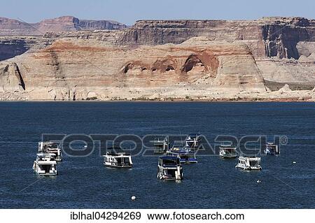 Red Navajo Sandstone cliffs at Lake Powell, houseboats in Wahweap Bay, Page, Arizona, USA, North America View Large Photo Image Stock Photo - Red Navajo Sandstone cliffs at Lake Powell, houseboats in Wahweap Bay, Page, Arizona, USA, North America. Fotosearch