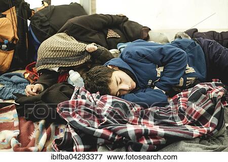 Refugees sleeping in the tent, waiting for the onward journey to Germany, first reception facility on the border with Austria, Wegscheid, Bavaria, Germany, Europe View Large Photo Image Stock Photo - Refugees sleeping in the tent, waiting for the onward journey to Germany, first reception facility on the border with Austria, Wegscheid, Bavaria, Germany, Europe. Fotosearch