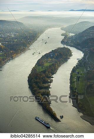 Picture - Rhine with cargo ships in the mist, Rhine island Nonnenwerth in Bad Honnef, Rhine Valley, behind Siebengebirge, North Rhine-Westphalia, Germany, Europe. Fotosearch