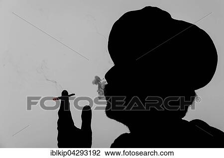 Silhouette of a Rajasthani man with a turban smoking a cigarette, Pushkar, Rajasthan, India, Asia View Large Photo Image Stock Image - Silhouette of a Rajasthani man with a turban smoking a cigarette, Pushkar, Rajasthan, India, Asia. Fotosearch