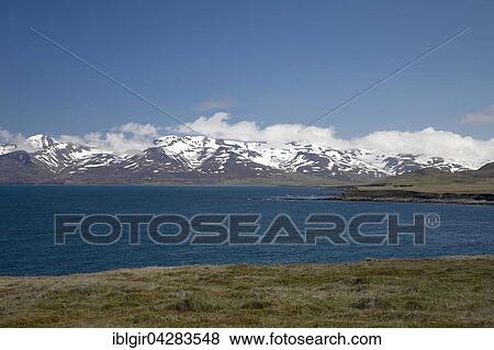 Snowy mountains along bay north of Trollaskagi Peninsula, Iceland, Europe View Large Photo Image Stock Photo - Snowy mountains along bay north of Trollaskagi Peninsula, Iceland, Europe. Fotosearch