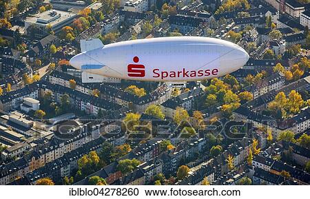 Stock Image - Sparkasse blimp advertising above Ruttenscheid, Essen, Ruhr district, North Rhine-Westphalia, Germany, Europe. Fotosearch
