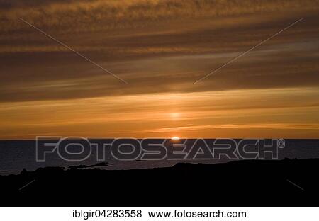 Stock Photo - Sunset over ocean, Iceland, Europe. Fotosearch