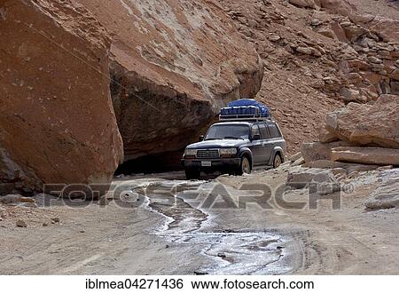 SUV truck on an unpaved road in a rocky canyon, Altiplano, border triangle of Bolivia, Chile, Argentina, South America View Large Photo Image Stock Photograph - SUV truck on an unpaved road in a rocky canyon, Altiplano, border triangle of Bolivia, Chile, Argentina, South America. Fotosearch