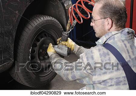 Stock Photo - Tire repair shop, auto mechanics, control and change of summer and winter tires on a car, Dusseldorf, North Rhine-Westphalia, Germany, Europe. Fotosearch