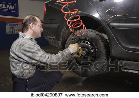 Tire repair shop, auto mechanics, control and change of summer and winter tires on a car, Dusseldorf, North Rhine-Westphalia, Germany, Europe View Large Photo Image Stock Photo - Tire repair shop, auto mechanics, control and change of summer and winter tires on a car, Dusseldorf, North Rhine-Westphalia, Germany, Europe. Fotosearch