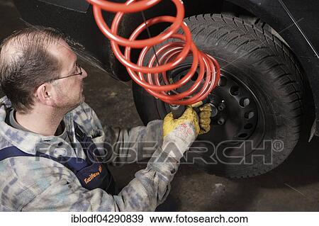 Tire repair shop, auto mechanics, control and change of summer and winter tires on a car, Dusseldorf, North Rhine-Westphalia, Germany, Europe View Large Photo Image Stock Photo - Tire repair shop, auto mechanics, control and change of summer and winter tires on a car, Dusseldorf, North Rhine-Westphalia, Germany, Europe. Fotosearch
