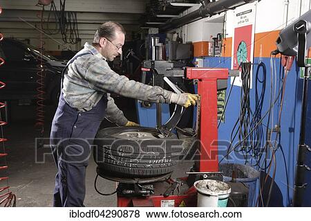 Tire repair shop, auto mechanics, control and change of summer and winter tires on a car, Dusseldorf, North Rhine-Westphalia, Germany, Europe View Large Photo Image Stock Photo - Tire repair shop, auto mechanics, control and change of summer and winter tires on a car, Dusseldorf, North Rhine-Westphalia, Germany, Europe. Fotosearch