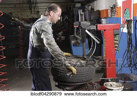 Tire repair shop, auto mechanics, control and change of summer and winter tires on a car, Dusseldorf, North Rhine-Westphalia, Germany, Europe View Large Photo Image Stock Photo - Tire repair shop, auto mechanics, control and change of summer and winter tires on a car, Dusseldorf, North Rhine-Westphalia, Germany, Europe. Fotosearch
