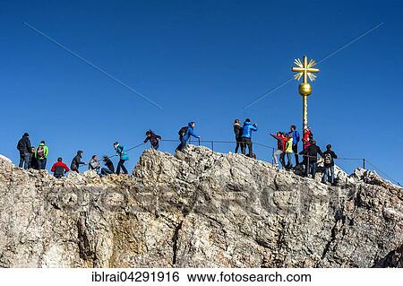 Tourists, summit cross on the Zugspitze, Garmisch-Partenkirchen District, Wetterstein, Alps, Upper Bavaria, Bavaria, Germany, Europe View Large Photo Image Stock Photograph - Tourists, summit cross on the Zugspitze, Garmisch-Partenkirchen District, Wetterstein, Alps, Upper Bavaria, Bavaria, Germany, Europe. Fotosearch