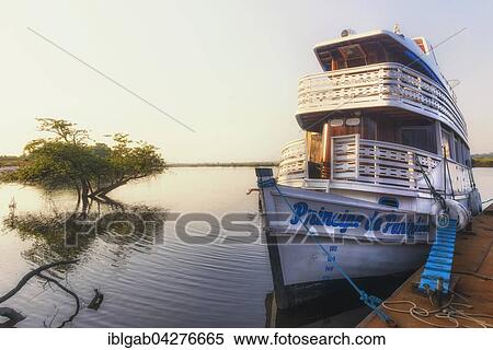 Stock Photography - Traditional wood boat navigating on the Amazon river, Amazonas state, Brazil, South America. Fotosearch