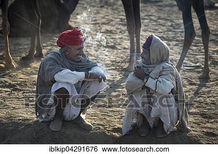 Two men having a break, Pushkar Camel Fair, Pushkar, Rajasthan, India, Asia View Large Photo Image Stock Photograph - Two men having a break, Pushkar Camel Fair, Pushkar, Rajasthan, India, Asia. Fotosearch