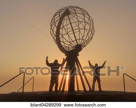 Stock Photo - Two men next to the globe at the North Cape platform Nordkapplataet, midnight sun, Nordkapp, Mageroya, Finnmark County, Norway, Europe. Fotosearch