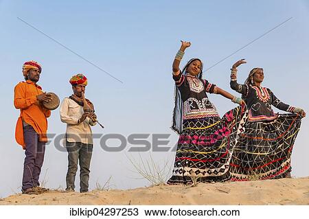 Stock Image - Two women dancing, musicians, Pushkar, Rajasthan, India, Asia. Fotosearch