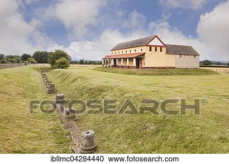 Stock Image - Wroxeter Roman City, replica of a Roman town house with ditch showing bases of original columns and their depth below current surface, Wroxeter, Shropshire, England. Fotosearch