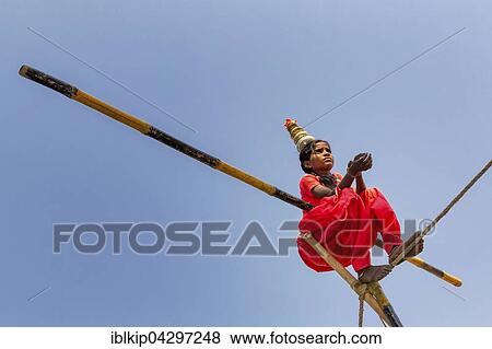 Stock Photo - Young girl balancing a on rope, Pushkar, Rajasthan, India, Asia. Fotosearch
