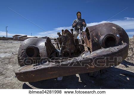 Young man sitting in rusty old car, Cementerio de los Trenes, Uyuni Municipality, Potosi Department, Altiplano, Bolivia, South America View Large Photo Image Stock Photo - Young man sitting in rusty old car, Cementerio de los Trenes, Uyuni Municipality, Potosi Department, Altiplano, Bolivia, South America. Fotosearch