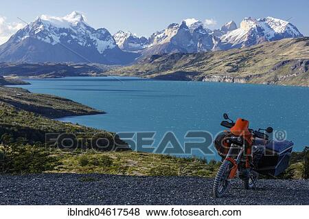 A heavily packed motorcycle on a gravel road behind the Lago del Torro and the mountain group Cordillera Paine, Torres de Paine, Region de Magallanes y de la Antartica, Chile. View Large Photo Image Stock Photo - A heavily packed motorcycle on a gravel road behind the Lago del Torro and the mountain group Cordillera Paine, Torres de Paine, Region de Magallanes y de la Antartica, Chile.. Fotosearch