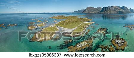 Aerial view, archipelago with grass, turquoise sea, steep mountains in the back, Gimsøy, Lofoten, Nordland, Norway, Europe View Large Photo Image Stock Photo - Aerial view, archipelago with grass, turquoise sea, steep mountains in the back, Gimsøy, Lofoten, Nordland, Norway, Europe. Fotosearch