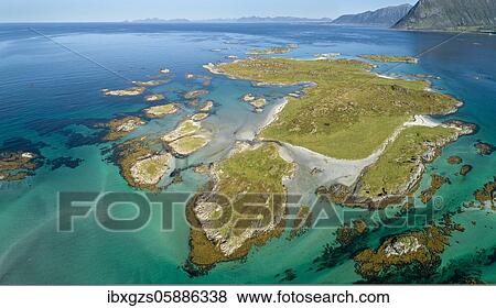 Stock Photo - Aerial view, archipelago with grass, turquoise sea, steep mountains in the back, Vågan, Lofoten, Nordland, Norway, Europe. Fotosearch