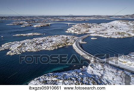 Aerial view, country road through the sea connects populated, small, winterly islands with the mainland, behind mountains, Herøy, Nordland, Norway, Europe View Large Photo Image Stock Image - Aerial view, country road through the sea connects populated, small, winterly islands with the mainland, behind mountains, Herøy, Nordland, Norway, Europe. Fotosearch