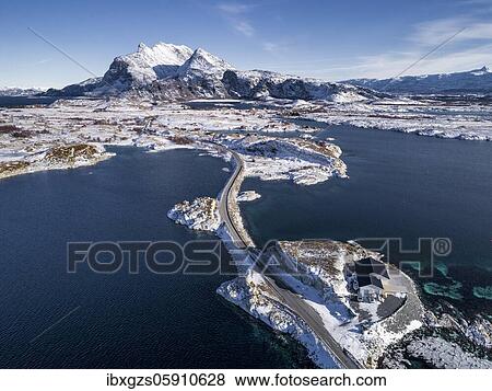 Aerial view, country road through the sea connects populated, small, winterly islands with the mainland, behind mountains, Herøy, Nordland, Norway, Europe View Large Photo Image Stock Photo - Aerial view, country road through the sea connects populated, small, winterly islands with the mainland, behind mountains, Herøy, Nordland, Norway, Europe. Fotosearch