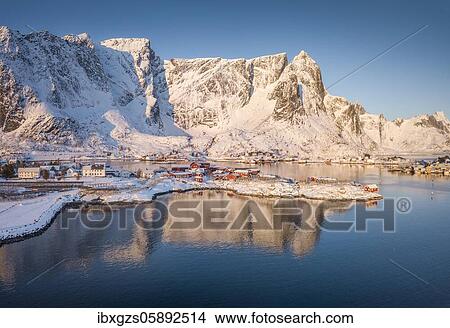 Picture - Aerial view, fjord landscape at sunrise, snowy mountains in winter, fishing village Reine, Nordland, Lofoten, Norway, Europe. Fotosearch