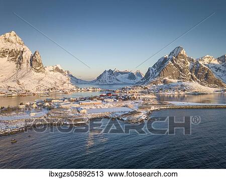 Aerial view, fjord landscape at sunrise, snowy mountains in winter, fishing village Reine, Reine, Nordland, Lofoten, Norway, Europe View Large Photo Image Stock Image - Aerial view, fjord landscape at sunrise, snowy mountains in winter, fishing village Reine, Reine, Nordland, Lofoten, Norway, Europe. Fotosearch