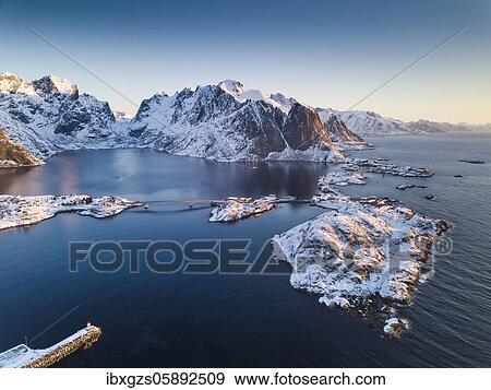 Aerial view, fjord landscape at sunrise, snowy mountains in winter, fishing village Reine, Reine, Nordland, Lofoten, Norway, Europe View Large Photo Image Stock Photo - Aerial view, fjord landscape at sunrise, snowy mountains in winter, fishing village Reine, Reine, Nordland, Lofoten, Norway, Europe. Fotosearch