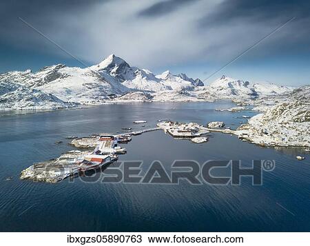 Stock Image - Aerial view, fjord with snowy mountains, small islands with fishing farms and stockfish drying racks, Sound, Nordland, Lofoten, Norway, Europe. Fotosearch