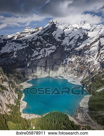 Aerial view, Lake Oeschinen with snow-covered mountains, Kandersteg, Bernese Oberland, Switzerland, Europe View Large Photo Image Stock Image - Aerial view, Lake Oeschinen with snow-covered mountains, Kandersteg, Bernese Oberland, Switzerland, Europe. Fotosearch